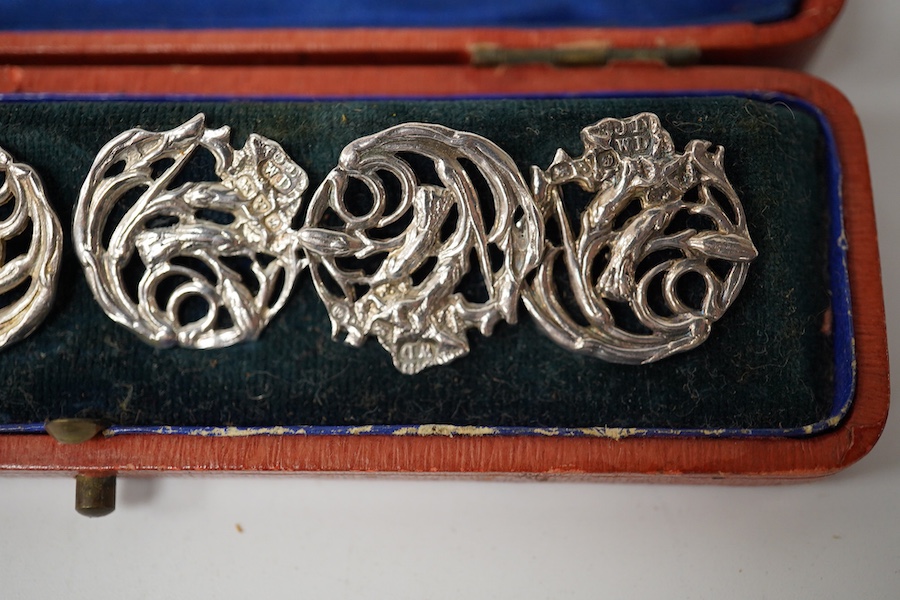 An Edwardian cased set of 6 Art Nouveau silver buttons, cast with stylised scrolling flowers, James Deakin & Sons, Chester 1904, 20mm. Condition - good